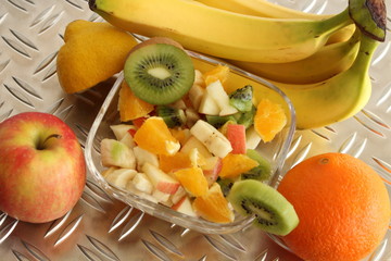 delicious fruit salad with banana, kiwi, apple and orange