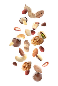 Different Nuts Falling On White Background