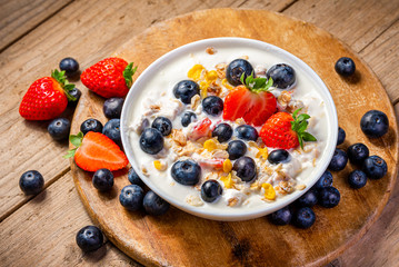 Yogurt with granola, strawberries and blueberries.