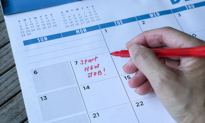 Start new job words written on table calendar with red marker