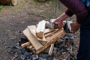 a woman sets fire to a fire