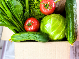 Large box with food, fresh vegetables and herbs.