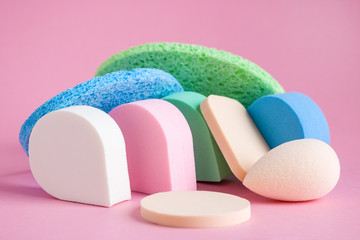 make up cosmetic sponges blenders assorted shape on pink background close up