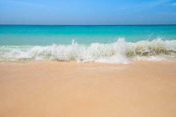 Beautiful sea waves on gold sandy beach and crystal clear water. Fine soft light sand at tropical seashore on exotic Koh Rok beach, Koh Lanta island, Thailand, Andaman Sea. Summer nature background.