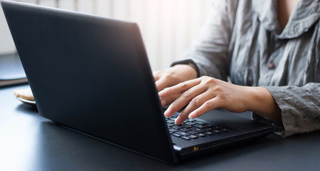  Close-up view of businesswomen using laptop computer working at home, Concept work from home