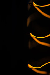 Macro shot of glowing wire of edison lamp on black background with copy space