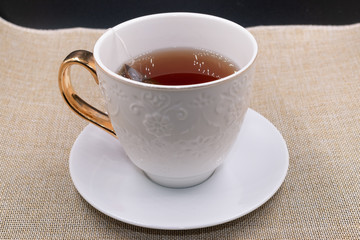 A cup of tea on a white fancy cup
