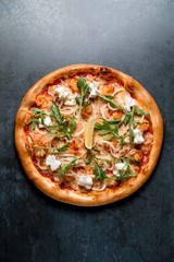 Italian pizza with cheese shrimp squid seafood arugula on black background