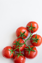 Healthy food ingredient - raw tomatoes on white background, vibrant colours, vitamin food, space for text