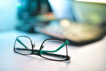 Close up image of eyeglasses on the desk