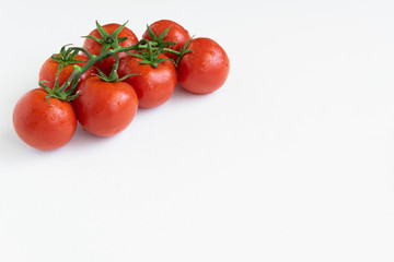 Healthy food ingredient - raw tomatoes on white background, vibrant colours, vitamin food, space for text