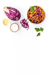Healthy vegan salad with red cabbage on white kitchen table form above space for text