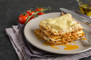 Meat lasagna on a wooden background.