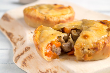  meat pie on wooden table close-up with copy space