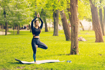 Young Caucasian woman doing yoga in the Park.