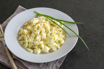 scrambled eggs on a white plate. the view from the top.