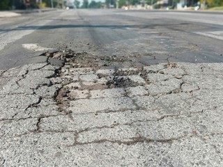 Cracks in the road are dangerous to drive.