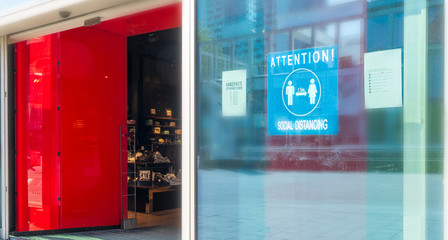 The blue sticker on the window in shopping centrum as a practicing of the Social Distance during the Covid-19 pandemic
