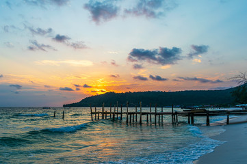 Obraz premium Sok San Beach, Koh Rong, Cambodia- Feb, 2020 : a wooden pier and a beautiful sunset from the Sok San Beach, Koh Rong, Cambodia