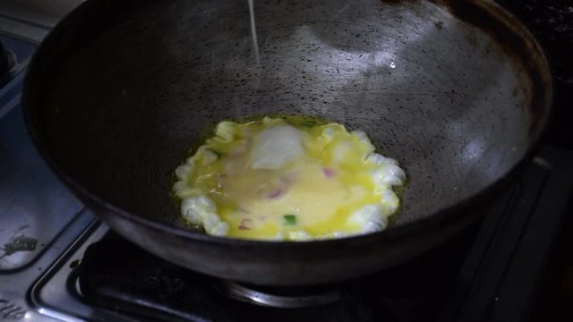 Preparing Indian omelette in a round vessel called as Karhai in hindi 