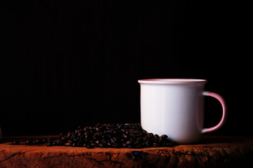 close up coffee cup and coffee beans on wood table