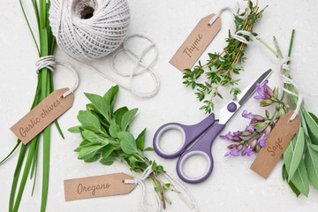 Fototapeta na wymiar Fresh herbs with tags and scissors 