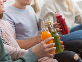 Modern friends drinking colored healthy detox smoothie