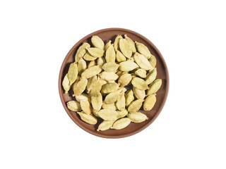 Spice green cardamom seeds on brown clay plate isolated on white