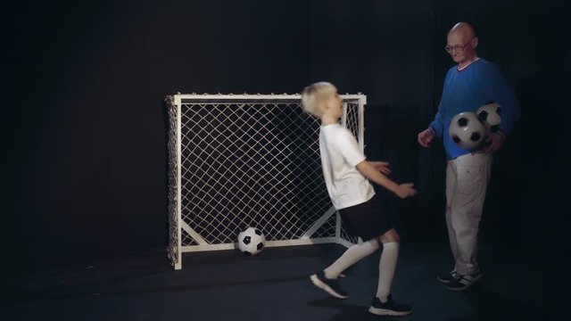 Footballer Boy Is Performing His Soccer Skills To Old Man
