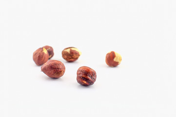 A few hazelnuts isolated on a white background. Well suited for baking or in healthy muesli.