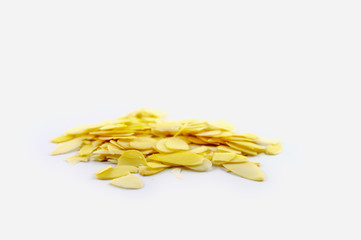 Sliced light almonds isolated against white background. Baking ingredients for the holidays.