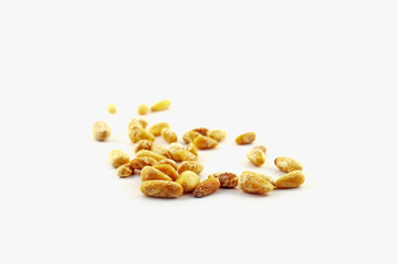 Loose pine nuts, without pine cones, lie isolated on a white background