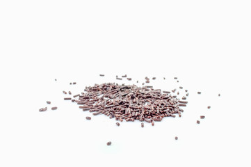 A pile of chocolate sprinkles in random order isolated against a white background.