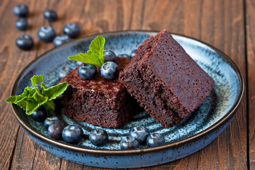 Homemade chocolate brownies on wooden background