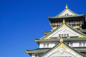 OSAKA, JAPAN, January 13, 2019 : Closeup and crop Osaka castle on bright blue sky background.