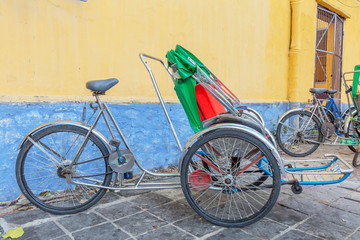 Fototapeta na wymiar Cyclo on a street of Hoi An old town,Quang Nam, Vietnam.