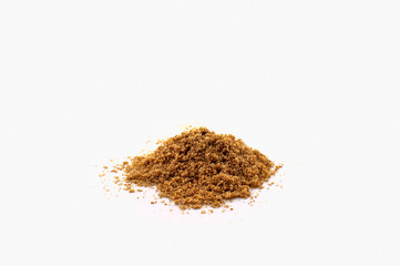 A pile of ground peppers of various types at different grindings isolated on a white background.