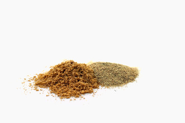 A pile of ground peppers of various types at different grindings isolated on a white background.