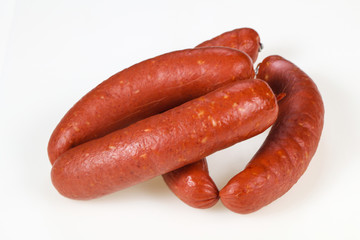 Tasty meat sausages over white background