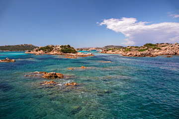 Panoramic view of the pink granite rock formations and the clear and transparent waters in the Maddalena archipelago in Sardinia, Italy.