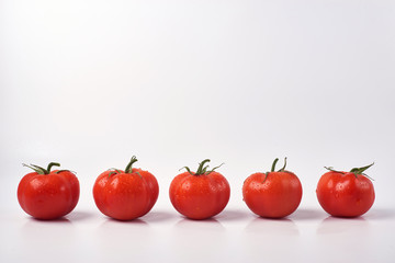 Tomato isolate. Tomato on a white background. Tomatoes top view, side View. With the path cut off.