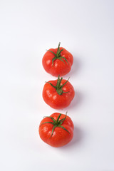 Tomato isolate. Tomato on a white background. Tomatoes top view, side View. With the path cut off.