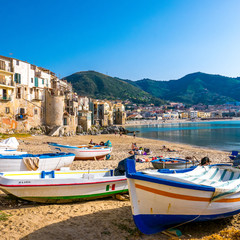 Sicily, Cefalu, Palermo. Seaside life scene with coloured tiny houses facing the sea.