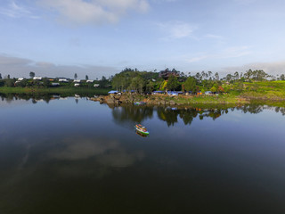 Fototapeta na wymiar Bandung Indonesia June, 4 2020: Beautiful Lake Patenggang with green tea field in ciwidey Indonesia