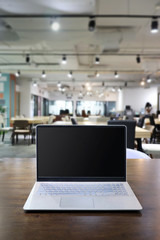 Laptop with blank screen on wooden table, Workplace with open laptop with black screen on wooden...