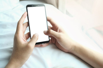 Mockup image of hand holding mobile phone with blank white screen