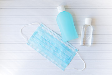 Blue medical mask, gel hand antiseptic, sanitizer. Disposable mask for protection against the virus. Coronavirus