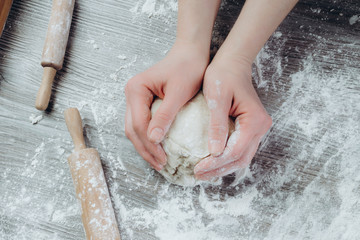 Woman hands kneading dough on the table