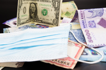 Surgical mask. Money. Economic crisis caused by the pandemic.