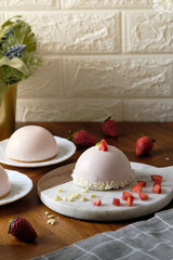 Strawberry Mousse Domes cake. set on cafe table.